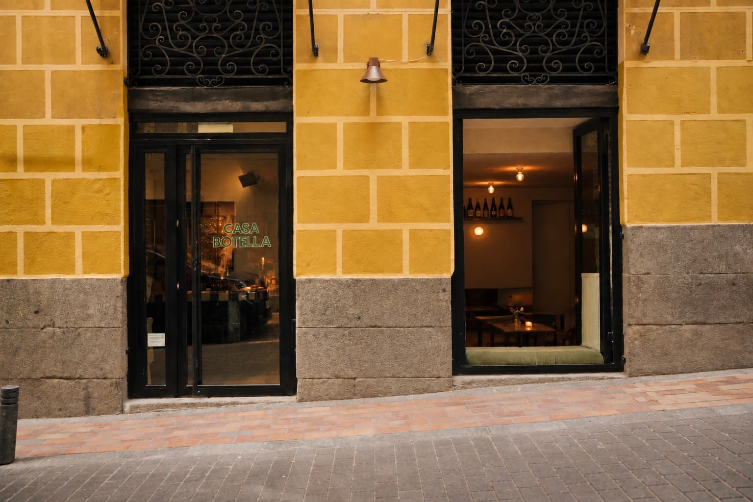 The warm yellow facade of Casa Botella in Malasaña
